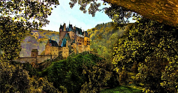 Eltz Castle seen through the trees, Treis-Karden, Germany. Unsplash@Peter Justinger