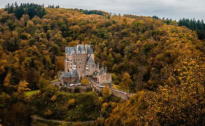 Eltz castle surrounded by gorgeous Fall foliage. unsplash:frederic-paulussen