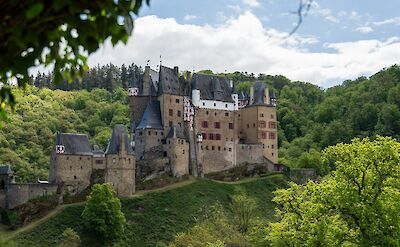 Eltz castle hidden in the lush green valley. unsplash:david emrich