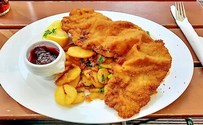 Wiener Schnitzel (breaded and fried veal or pork cutlet) is one of the most well-known German dishes. unsplash:markkonig