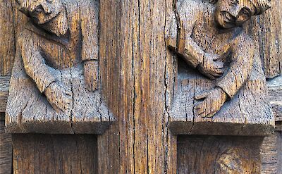 Intricate wood carvings commonly found in doorways of medieval towns like Moret-sur-loing. unsplash:freenomad