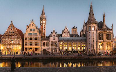 The medieval guild houses of Graslei light up along the Leie River, Ghent. pex@Dylan Chan