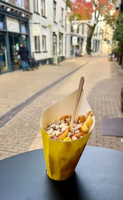 Patat oorlog, fries with mayo, satay (peanut) sauce, and onions in Holland. ©tripsite