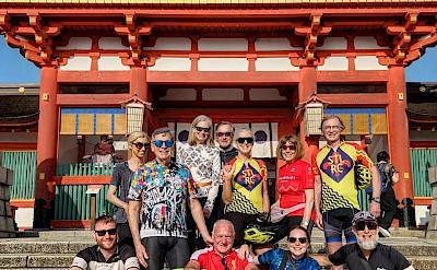Cyclists in front of a historic temple gate. toSR