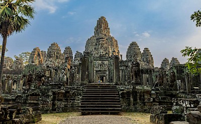 the iconic stone towers and serene faces of Bayon Temple. Pexels@Sergk1