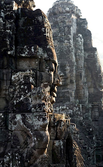 Faces on the temples at Angkor Wat, Cambodia bike tour. Unsplash@Wei Gao