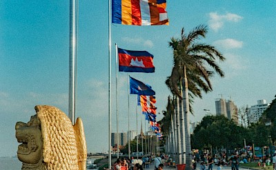 Flags in Phnom Penh, Cambodia bike tour. Unsplash@Daniel Bernard