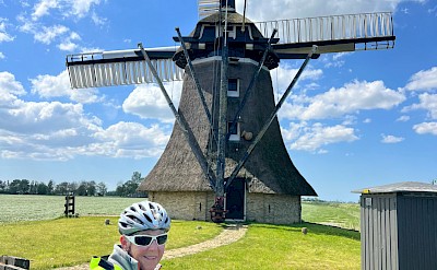 Cycling past an iconic Dutch windmill on tour. ©Hennie