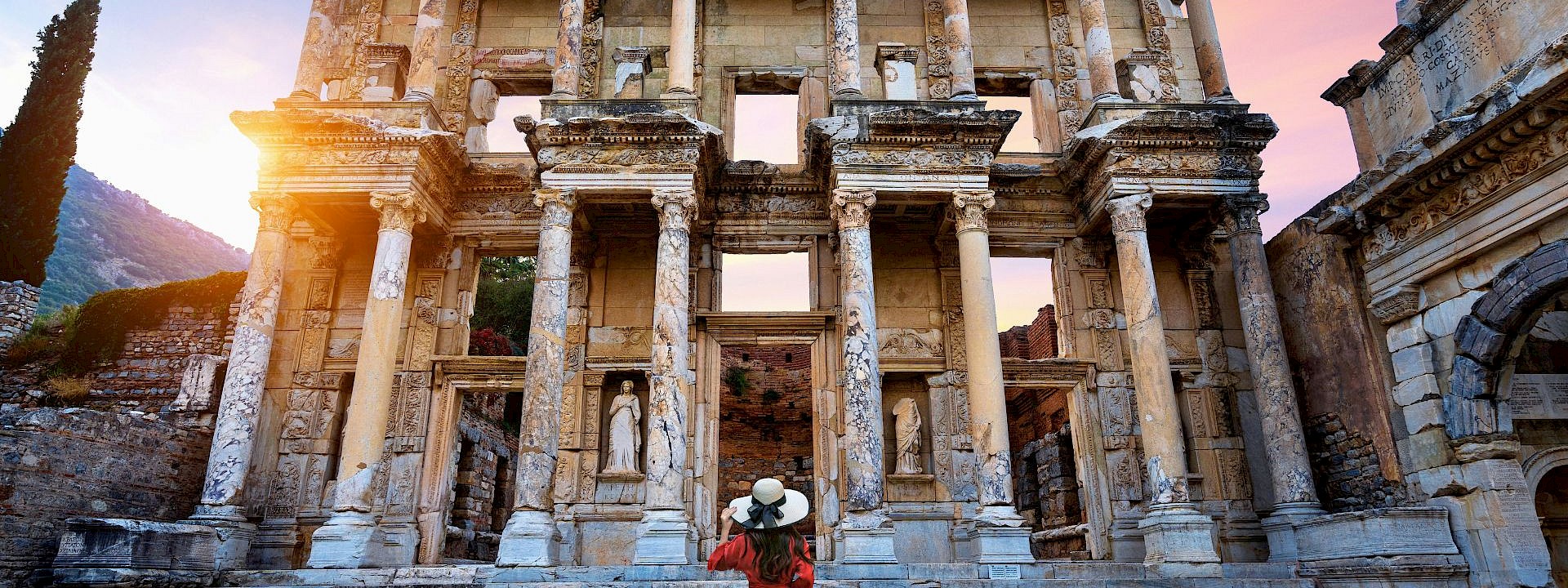 A woman admiring an ancient building. Unsplash@Getty Images