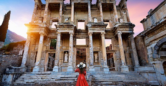 A woman admiring an ancient building. Unsplash@Getty Images