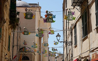 Whimsical birdcages in Alghero’s old town reflect its Catalan charm. Unsplash@JurgenScheeff