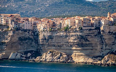 The old town of Bonifacio perched on sheer limestone cliffs. Unsplash@Christian Thoni