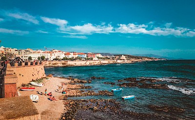 Colorful buildings along Alghero’s historic coast. Pexels@imagehunter