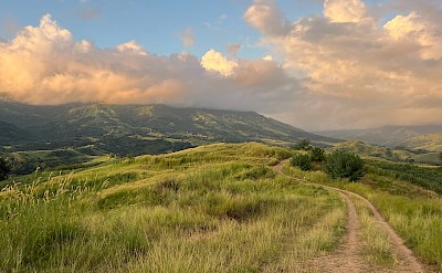 Soft golden light rolling across Fiji&rsquo;s highland hills at dusk. to-FIT