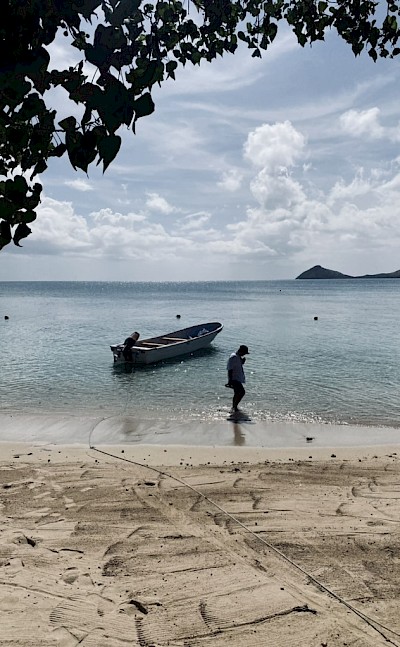 A quiet Fijian beach beside a traditional fishing boat. &copy;Mikky