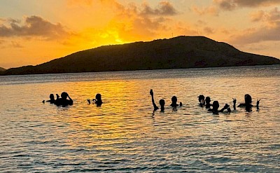 Enjoying a peaceful sunset swim in Fiji&rsquo;s calm waters. &copy;Mikky