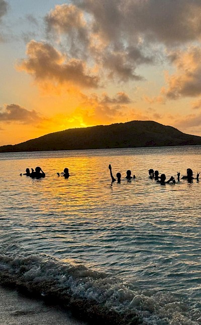 Enjoying a peaceful sunset swim in Fiji&rsquo;s calm waters. &copy;Mikky