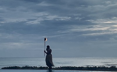 A traditional Fijian torch-lighting ceremony at dusk. &copy;Mikky