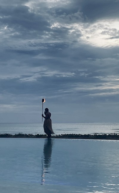 A traditional Fijian torch-lighting ceremony at dusk. &copy;Mikky