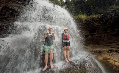 Standing under a tropical waterfall. to-FIT