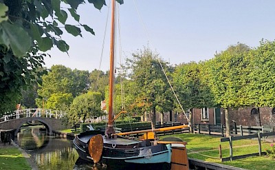 Boat on the canal in Enkhuizen, Netherlands. Unsplash@Fatemeh Alizadeh