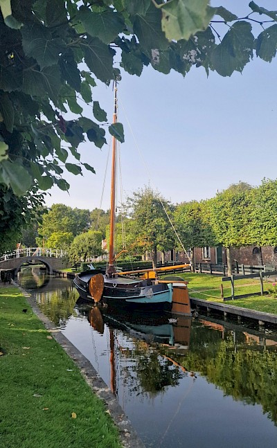 Boat on the canal in Enkhuizen, Netherlands. Unsplash@Fatemeh Alizadeh