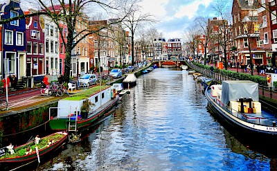 Boats on a canal in Amsterdam, Netherlands. Unsplash@Massimo Virgilio