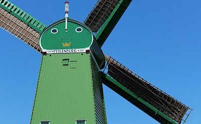 Green windmill, Zaanse Schans, Netherlands. Unsplash@Tamar