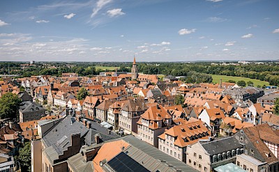Red rooftops, church towers, and tree-lined streets in the heart of Franconia. unsplash@tourist information