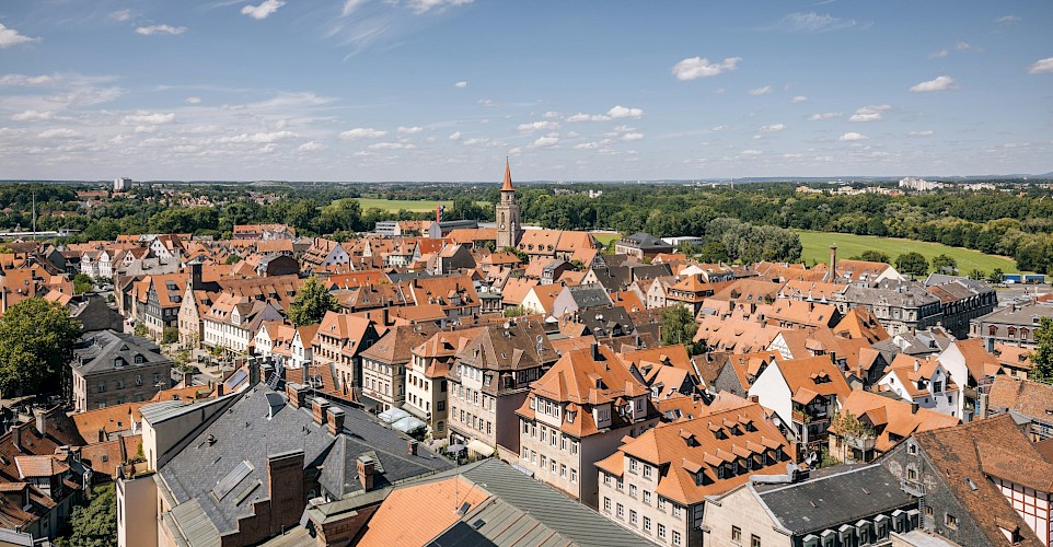 Red rooftops, church towers, and tree-lined streets in the heart of Franconia. unsplash@tourist information