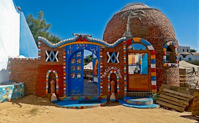 A bright, colorful entrance painted in traditional Nubian patterns. unsplash@thales botelho-de-sousa