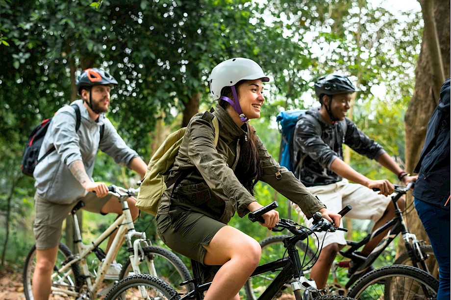 Cycling through a forest. Unsplash@Curated Lifestyle