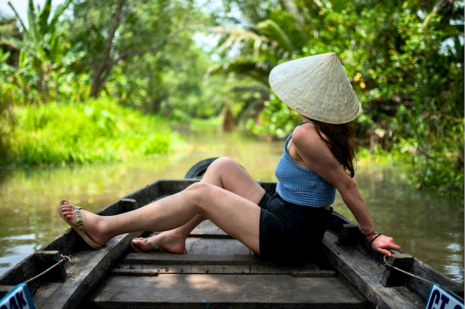 Relaxing on a boat in a conical hat. Unsplash@Monika Guzikowska