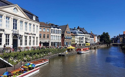 Colorful boats and historic facades along the Graslei in Ghent. pexels@henning shi