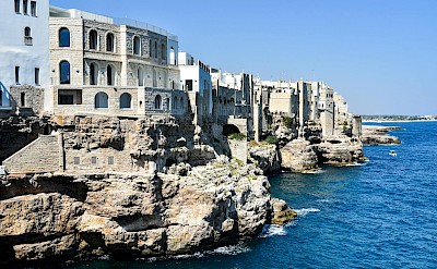 Limestone cliffs and whitewashed buildings of Polignano a Mare. Pexels@AXPphotograghy