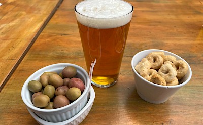 Local olives, taralli, and craft beer enjoyed at a café in Puglia. cc@Heather