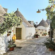 Cycling Puglia – The Heel of Italy - Plants in the streets of Alberobello, Puglia, Italy. Unsplash@Reisetopia