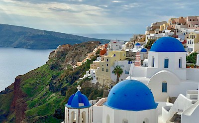 Blue-domed churches and caldera scenery in Santorini. Unsplash@yang yang