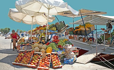 Traditional fruit stand at a seaside market. Unsplash@Vasilis Caravitis