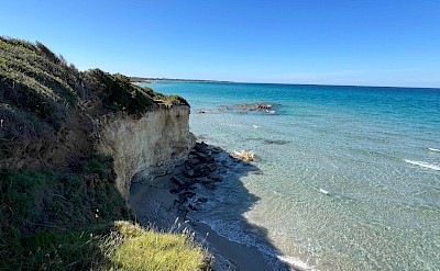 A quiet beach tucked beneath coastal cliffs on the Adriatic side &copy;Heather