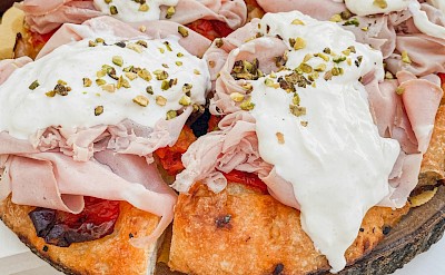 Classic Puglian focaccia topped with fresh mozzarella and local cured meats. unsplash@LuciaGherra