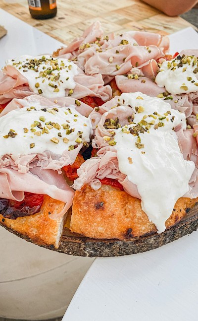 Classic Puglian focaccia topped with fresh mozzarella and local cured meats. unsplash@LuciaGherra