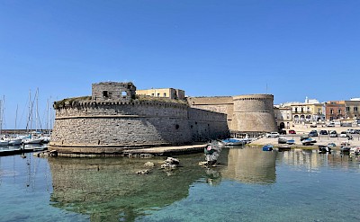 Gallipoli Castle reflected in the calm harbor waters. Flickr@Gian Luca Sgaggero