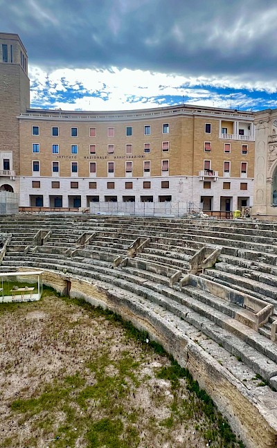 The Roman amphitheater in Lecce set against Baroque architecture &copy;Heather