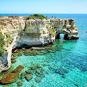 Cycling Italy’s Salento Coast - Dramatic limestone cliffs and crystal-clear water along the Salento coast. unsplash@MassimoVirgilio