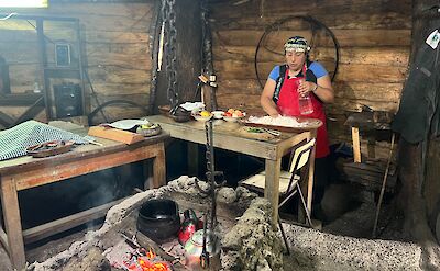 Cooking over a traditional fog&oacute;n in a Mapuche-style ruka