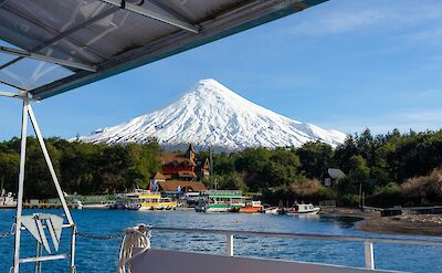Harbor views with Osorno Volcano rising above Puerto Varas. unsplash@TrevorVannoy