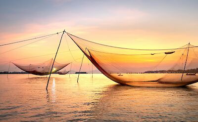 Fishing nets at sunset on Kerala&rsquo;s coast. pexels@QuangNguyenVinh