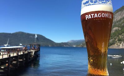 A cold Patagonian beer by the lake on Argentina to Chile bike tour. toAT