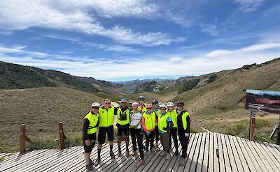Group photo and stunning lookout on Argentina to Chile bike tour. toAT